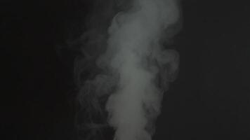 Stream of smoke coming from the bottom up of the screen against black background video