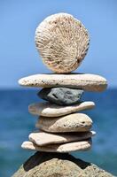 Towering Stack of Meditation Stones by the Ocean photo
