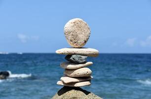 Stones and Tumbled Coral Balanced by the Ocean photo