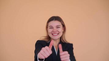 a woman in a suit is giving the thumbs up video