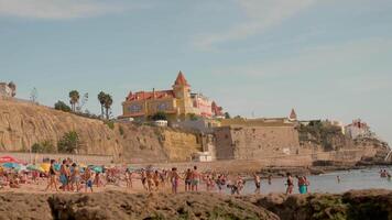 a crowded beach with people and umbrellas video