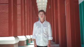 a woman in a white shirt standing in an alley video