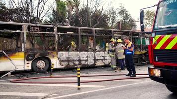 firefighters stand near a fire truck on a street video