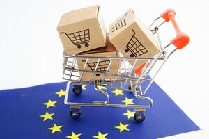 Online shopping, Shopping cart box on EU European Union flag, import export, finance commerce. photo