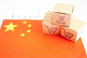 Online shopping, Shopping cart box on China flag, import export, finance commerce. photo