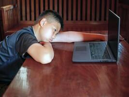 Asian kid boy short hair Upset, sitting in the dark, thinking about conflicts, family relationships. sad face, Emotion sad and sad face, depression children concept photo