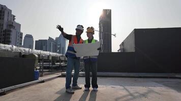 male man woman female person people human look see watch planning project site white yellow hardhat safety helmet pointing finger cheerful teamwork group labor day development business real estate video