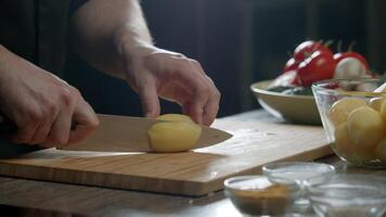 The cook cuts potatoes in the kitchen of the restaurant video