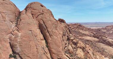 Drone video of a flight along the Spitzkoppe in Namibia during the day against a blue sky