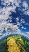 vertical video with tiny planet in sky with clouds. Transformation of spherical 360 panorama in abstract aerial view.