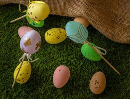 Easter eggs colored on green grass. Congratulations on Easter photo