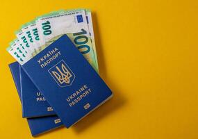 ukrainian passport and 100 euro banknotes photo