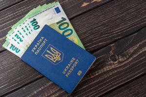 ukrainian passport and 100 euro banknotes photo