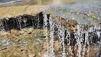 Water flows from top to bottom through the cave inside video