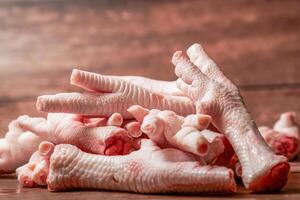 pile of clean chicken feet on a wooden background photo