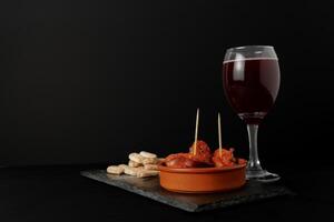 chorizo frito ,typical spanish tapa in a clay pot photo