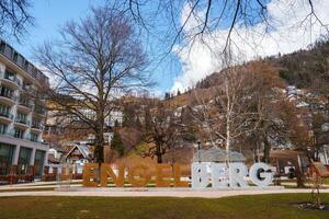 Engelberg Resort's Elegant Sign and Opulent Hotel Amidst Alpine Scenery photo