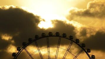 Ferris wheel gyrating at cloudy day at sunset video