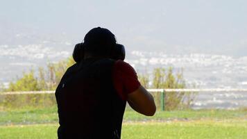 Malaga, Spain, 2017 - Silhouette of a shooter skeet shooting in a competition video