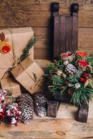 Christmas Gifts with Boxes on Wooden Background. Vintage Style. Closeup, selective focus. Toy, bear, sled. Christmas concept. photo