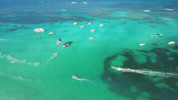 Aerial view overhead perspective of swift boat navigating Caribbean Sea, showcasing vibrant coral reef below and offering expansive vistas of azure waters. Very delicious tropical picture video