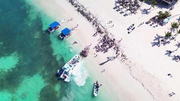 People board a tourist catamaran to embark on tour of tropical. bird's eye view video