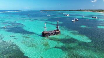 Pirate ship floating in caribbean sea. Dominican Republic. Aerial top view video