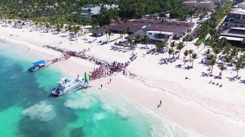 People board a tourist catamaran to embark on tour of tropical. bird's eye view video