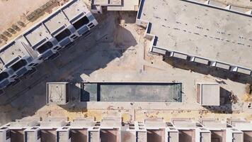 Abstract Aerial View of New Under Construction Residence with Empty Pool, Builders at Work. Copy Space. Camera Zoom Out video