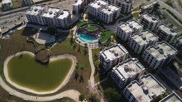 New district. View from above. Construction of apartment buildings. Camera flies over built low-rise buildings. Villas. Vista Cana, Dominican. Drone view building under construction, flying forward. video