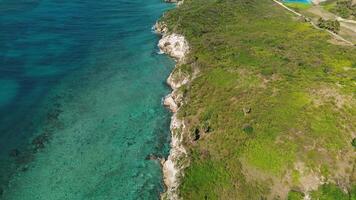 Area view of Colorful waters of ocean, swirl around rocky and scenic coastline video