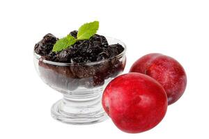 Dried plum in a glass bowl isolated on a white background front view photo