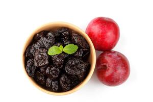 Dried plum in ceramic bowl isolated on a white background top view photo