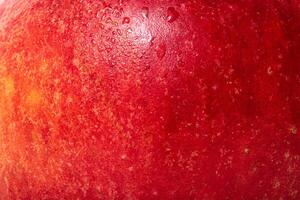 The texture of an apple is red with yellow. Apple skin with water drops. photo