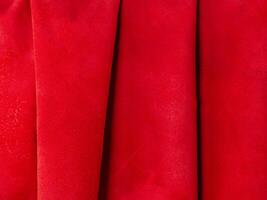 Natural red suede with folds as a background. photo