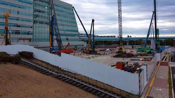 A timelapse of crane at the under construction near the railway wide shot panning video