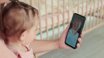 Childcare at Home, Child Protection, New Life, Leisure with Baby. Mom and child during an online call with dad at home video