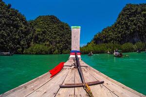 Aerial panorama of Thailand's verdant, lush tropical island, National Park Island, with blue and aquamarine the sea, and clouds shining by sunlight in the background. photo