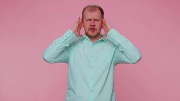 Frustrated irritated man covering ears, avoiding advice ignoring unpleasant noise loud voices video