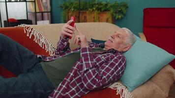 Senior grandfather use mobile cell phone online shopping, found out great big win, celebrate at home video