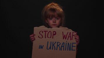 Homeless girl kid showing cardboard massage Hands Off Ukraine, crisis war, no peace, stop aggression video