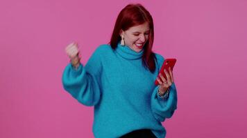 Happy excited girl use mobile phone say wow yes found out great big win news doing winner gesture video