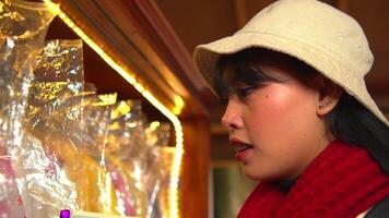 Woman in a white hat and red scarf smiling indoors with warm lighting video