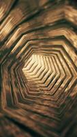 Vertical video - flying through an empty bright shiny metallic tunnel of golden hexagonal rings endlessly rotating. Full HD and looping gold colored luxury motion background animation.