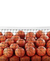 Several basketball balls in the net white background photo