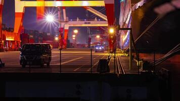 A night timelapse of crane near the container port in Tokyo tilt video