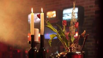 romantic atmosphere with candles in bottles and decor from TVs on the wall video