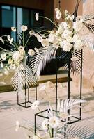 Wedding semi-arch of flower bouquets stands in the courtyard photo