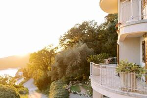 Green garden near mansion with terraces in bright sunlight photo