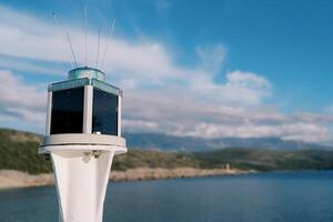 Marine solar powered LED lantern on a pole by the sea photo